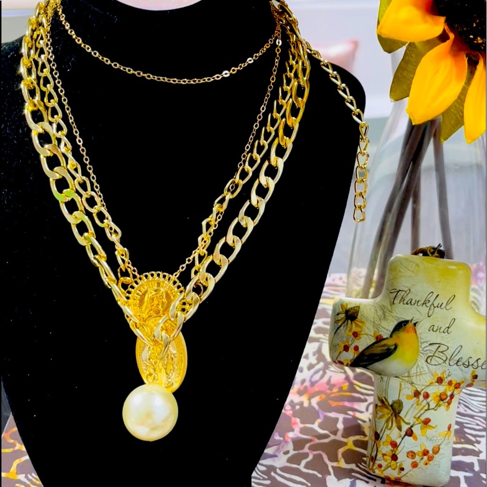 beautiful fine fantasy necklace with several chains and a large pearl